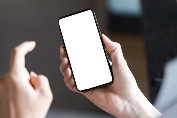 Individual holding a smartphone with a blank screen, ready for app usage or communication.