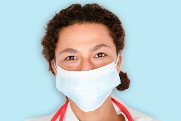 Studio portrait of black woman doctor on blue background