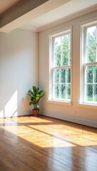 Fototapeta premium An empty room with white walls and hardwood floors.