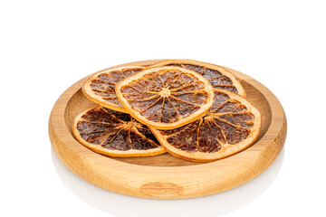 Dried grapefruit slices on a wooden plate, macro, isolated on a white background.