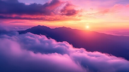 sunset, with clouds below, glowing in soft pinks and purples. The distant peaks emerge from the mist, bathed in golden twilight.
