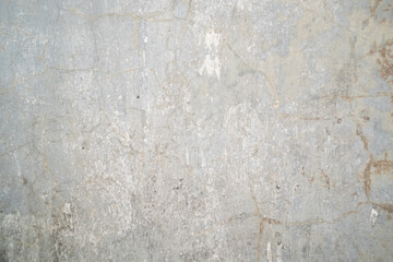 A textured pattern on a cement wall, showcasing its rough, uneven surface and industrial aesthetic