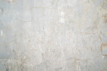 A textured pattern on a cement wall, showcasing its rough, uneven surface and industrial aesthetic