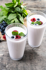 Fresh raspberry and blueberry smoothie on wooden table.