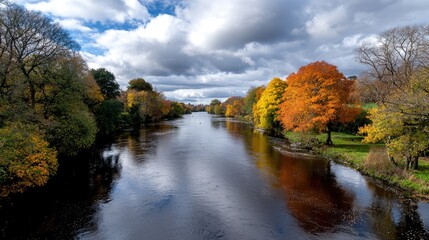 Fototapeta premium Autumn River Landscape Colorful trees reflected in calm water, cloudy sky