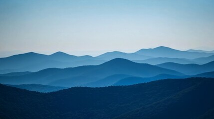 Fototapeta premium Layered mountain silhouettes under a blue sky minimalist landscape art style