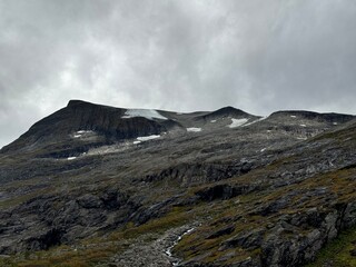 Mountains, cliffs, overcast and foggy.