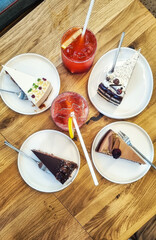 Top view of still life of plates with pieces of cake of different types