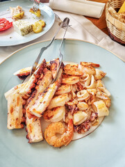 A delicious Mediterranean dish of grilled octopus, squids and shrimps served in a small restaurant on the Croatian riviera