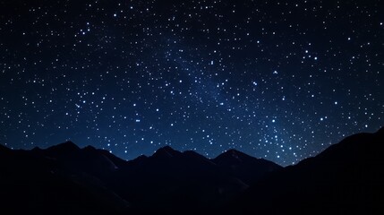 Starry night sky with clear constellations dark silhouette of mountains © earnjubu