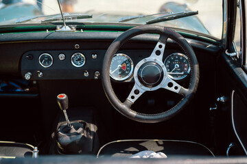 Interior of a Vintage Car Featuring Steering Wheel and Dashboard