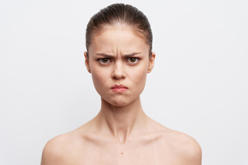 angry expression, serious face, emotion, portrait of a woman against a white background, simple and...