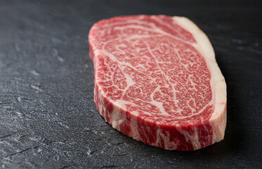 Raw Wagyu Beef Steak with Rich Marbling on Black Slate Surface for Gourmet Cooking and Fine Dining