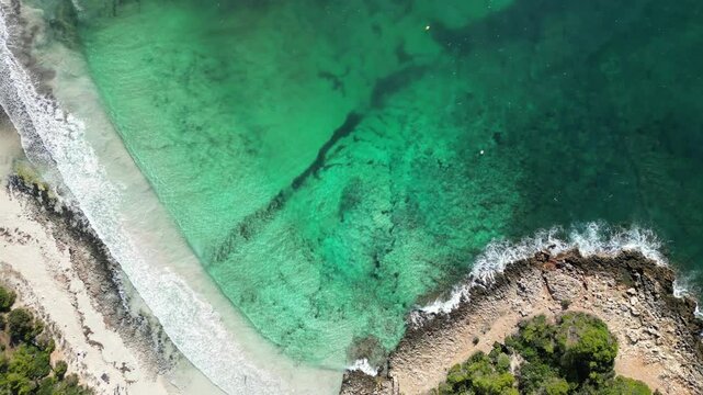 The turquoise beach of Son Saura in Menorca, with rough seas Balearic Islands