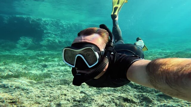 Lone man snorkeling in the turquoise waters of Ibiza, Balearic Islands