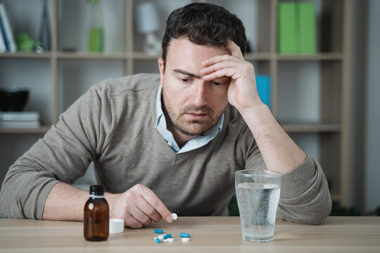 One man taking painkillers to relieve pain