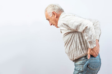 The older man grabbed his lower back. Radiculitis symptom, inflammation, pain in the spine of the...
