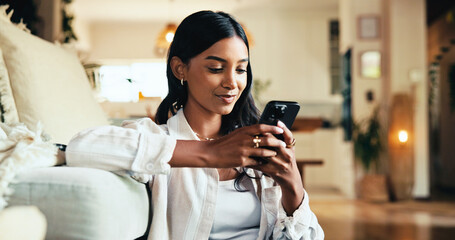 Woman, mobile and smile in home with social media, reading blog and interaction in online dating profile. Girl, happy or phone in living room for comfort, streaming video and typing for text message