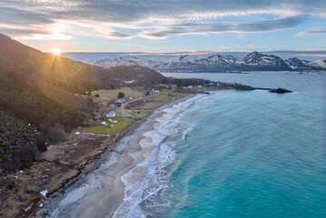 aerial photo of a wintry coastal landscape in the Bergsfjorden near Skaland on the Island of Senja in northern norway