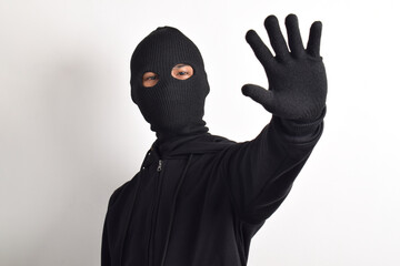 Thief wearing black jacket and mask isolated on white background. Robbery and criminal concept