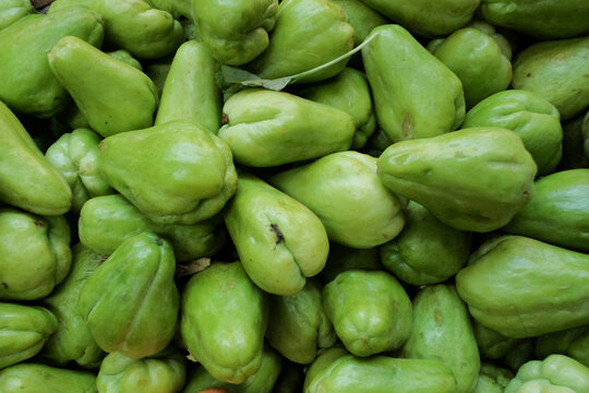 Fresh, ripe green chayote (Labu Siam) with smooth skin and firm texture, showcasing its natural freshness and vibrant color