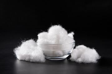 closeup of polyester stable fiber on black background. synthetic fibre