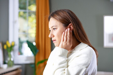 Young woman with ear pain