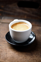 Cup of coffee on wooden background. Soft focus. Copy space