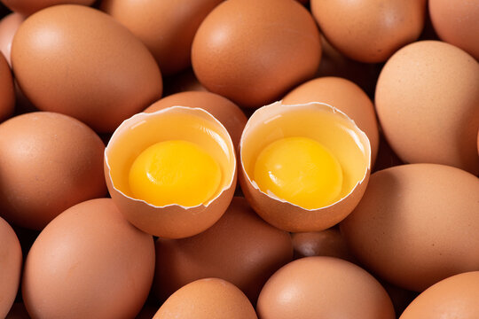 raw chicken eggs,Broken egg with yolk  background