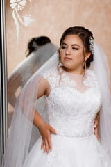 woman with makeup and hairstyle for wedding. She has fair skin, expressive blue eyes and neatly styled hair, decorated with a decorative clip with pearls and rhinestones.