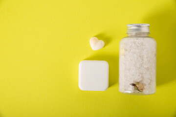 Bath gift set. Handmade soap and sea salt with milk and honey, aromatherapy. Yellow background, close-up. Copy space for text