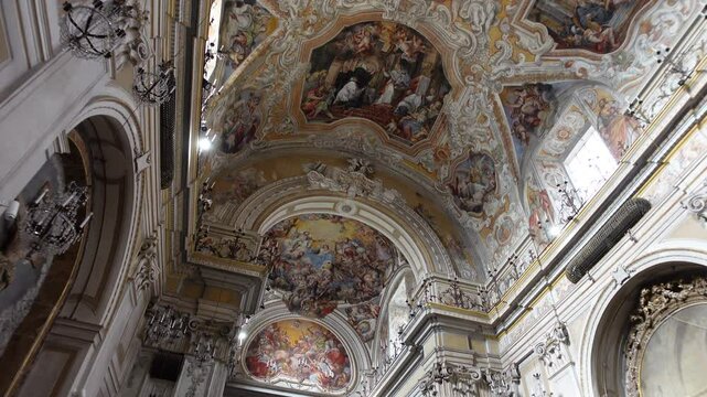 Gimbal shot of beautiful frescoes, decorating the ceiling of the beautiful San Benedetto church in Catania, Italy

