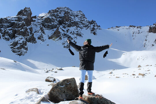 Woman enjoys the view of snow-capped mountains