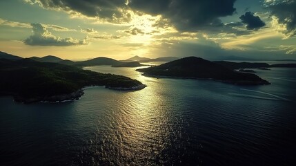 Aerial view of the tiny islands in a tropical ocean at sunset, with clouds and a calm sea surface, aerial drone photography, panorama.