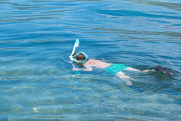 happy child enjoying snorkeling in sea water, enjoying active summer holidays, exploring underwater...