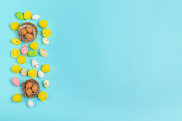 Colorful artificial Easter eggs on a blue background
