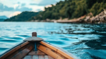 Obraz premium Serene boat ride on calm waters with lush green hills and a tranquil sky in the background