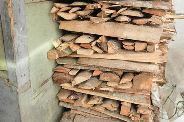 Selbstklebende Fototapeten Neatly stacked firewood arranged outdoors, showcasing natural textures and earthy tones © Herman