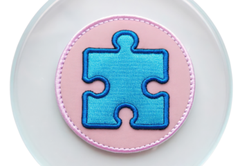 Colorful Embroidered Patch with Puzzle Piece Design on Soft Circular Background