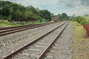 Fototapeta premium A double railway track captured from a perspective view, creating depth and leading lines into the distance