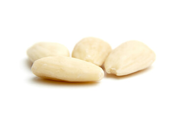 Four smooth blanched almonds displayed close-up on a white background, showcasing their creamy texture and natural appeal. Perfect for healthy food concepts