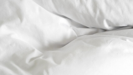 White soft bed linen with a clean duvet, creating a cozy background.