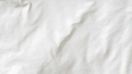 White clean bed linen background with soft folds and minimal texture.