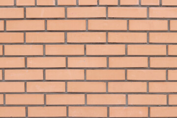 Brick wall texture, background. Orange brick wall background for exterior design. Construction concept, outdoor buildings, garage or house. Wall with classic checkerboard pattern and visible joints
