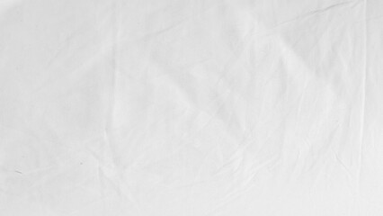 White clean bed linen background with soft folds and minimal texture.