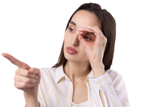 Close up portrait of attractive quirky young woman making binoculars with hands showing ok gesture on white studio background.