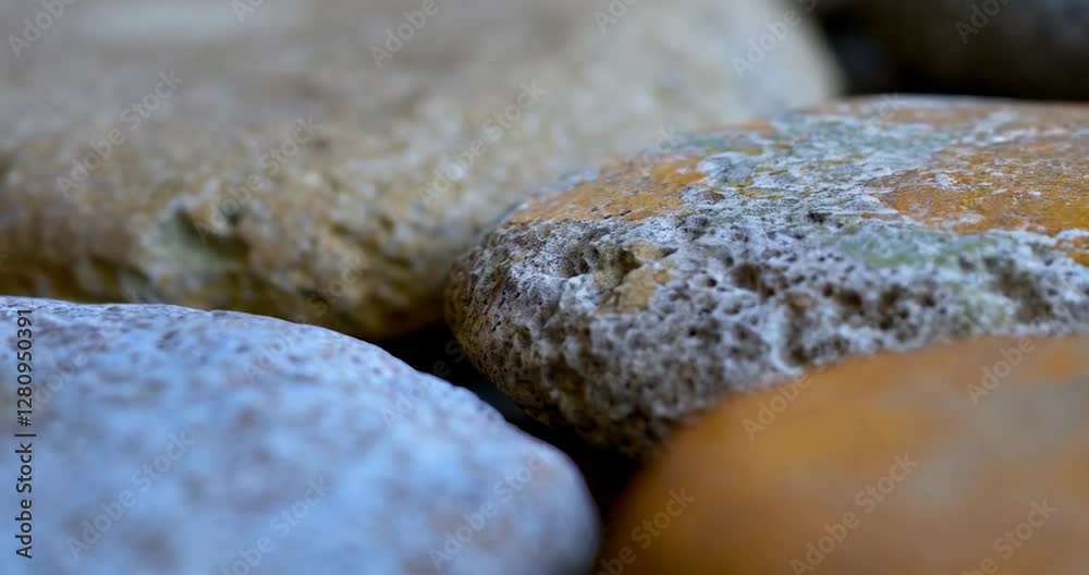 Poster Close-up view of smooth stones in muted tones with slight color variations in focus the blurred background