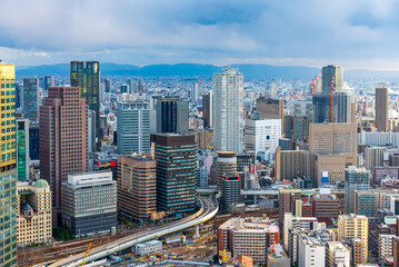 Naklejka premium Cityscape of Osaka city Japan Umeda skyline with cloudy sky.