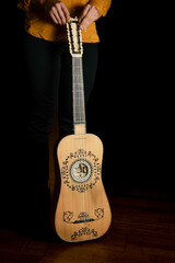 Vertical photo of a baroque guitar isolated on black background