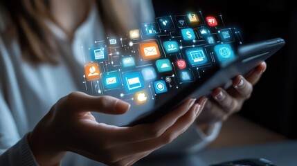 A person is holding a tablet displaying various applications, showcasing the diversity and functionality of modern digital tools.